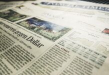 The Constantly Very Rich People Rundown in 2023. a newspaper with a dollar bill and graph